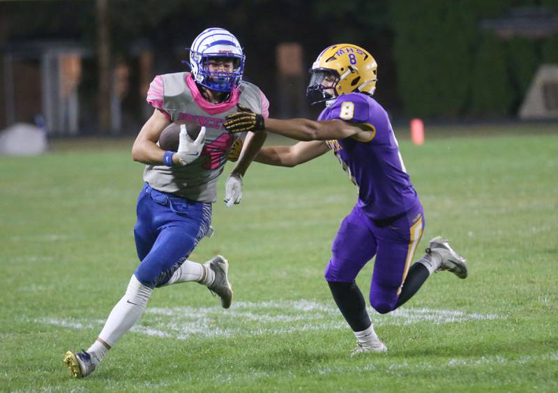 Princeton's Jack Oester carries the ball as Mendota's Wiliam Musanovic pushes him out of bounce on Friday, Oct. 10, 2025 at Bryant Field in Princeton.