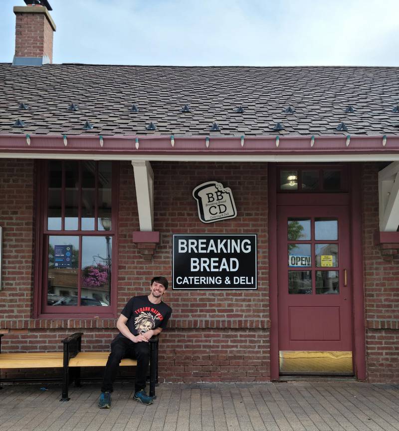 John Plazak sits outside the new Breaking Bread location at the downtown Crystal Lake train station.