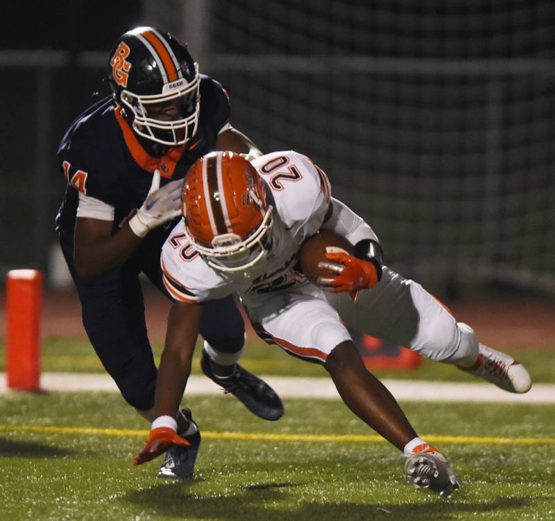 Joe Lewnard/jlewnard@dailyherald.com
Buffalo GroveÕs Jalon Marshall tackles HerseyÕs Brandon Jenkins, who intercepted a Bison pass in the end zone during FridayÕs game in Buffalo Grove.