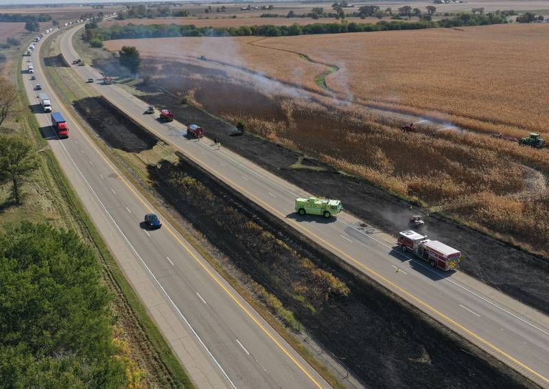 Firefighters extinguish a brushfire on Wednesday, Oct. 9, 2024 along Interstate 80 in the eastbound lane near mile post 65 in Bureau County. A MABAS box alarm was sent out around 11:45 a.m. and upgraded to a fourth-alarm. Interstate 80 was shut down in the Eastbound lane while firefighters doused the flames. Fire companies from Utica, Oglesby, Ladd, Bureau, Hennepin, Peru, La Salle, Spring Valley and others responded to the scene.