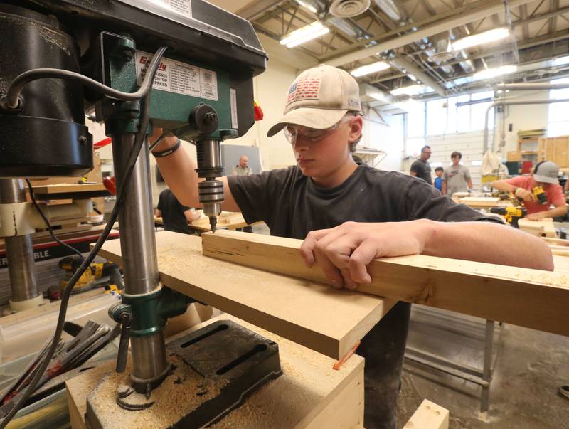 Jacob Picca uses a drill press to make a drill hole during the Area Career Center Hands-On Showcase on Thursday, June 8, 2023 at La Salle-Peru Township High School.