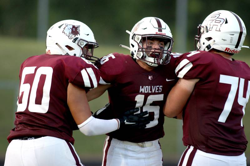 Prairie Ridge’s Dominic Creatore, center, is greeted after  running the ball in for a touchdown against Jacobs at Crystal Lake Friday night.
