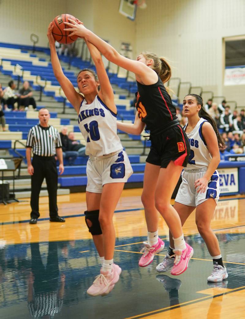 Geneva’s Peri Sweeney (10) rebounds the ball against Batavia’s Reagan Sulaver (30) during a basketball game at Geneva High School on Friday, Dec 15, 2023.