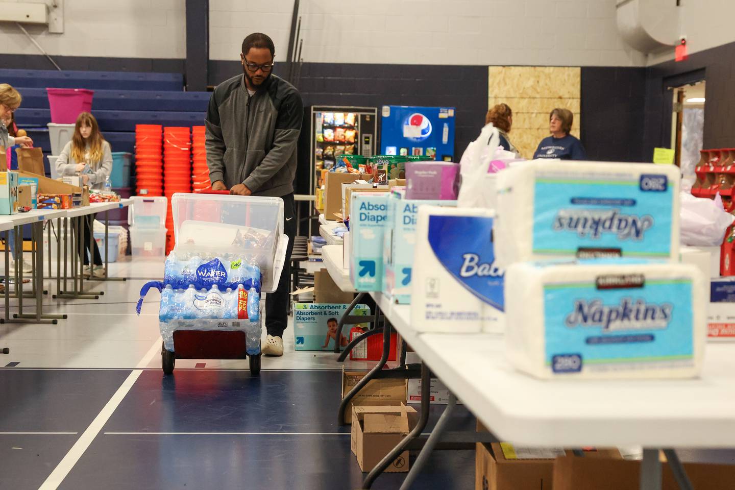 Jared Harris, of Kankakee, gathers supplies for his aunt at Grace Christian Academy on Thursday, March 12, 2026, following the EF-3 tornado that tore through Kankakee County on March 10.