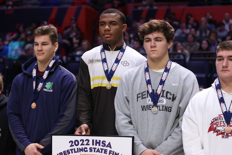 Joliet Catholic’s Dillan Johnson takes the podium as the Class 2A 285lb. champion at State Farm Center in Champaign. Saturday, Feb. 19, 2022, in Champaign.