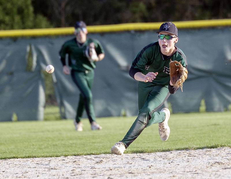Rock Falls’ Ethan Mathews fields a ball at short against Newman Wednesday, April 23, 2025.