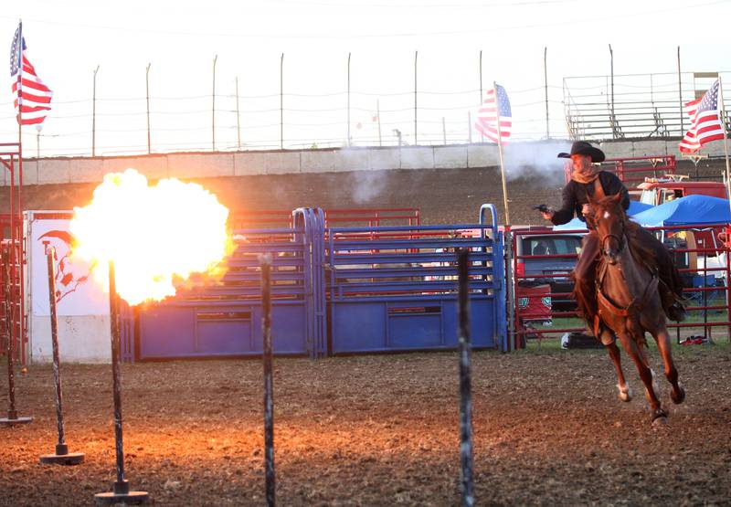 Chance Danison of Western Way Entertainment performance company in Sevierville, Tenn., shoots out a balloon of fire while riding horseback during the Starved Rock Rodeo on Saturday, June 21, 2025 at the La Salle Speedway.