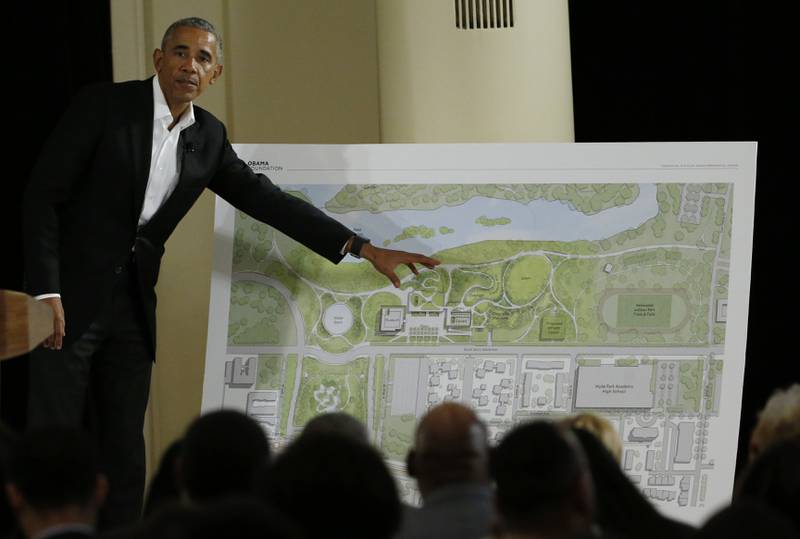 FILE - Former President Barack Obama points to a rendering for the former president's lakefront presidential center at a community event at the South Shore Cultural Center in Chicago on May 3, 2017. A federal judge on Tuesday, March 29, 2022, has dismissed a lawsuit that sought to prevent the construction of the Obama Presidential Center in a park on Chicago's South Side. (AP Photo/Nam Y. Huh, File)