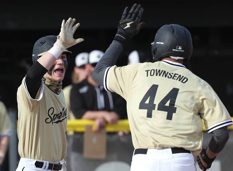 Sycamore's Hunter Britz congratulates Tommy Townsend after he scored a run during their game against LaSalle-Peru Monday, April 11, 2022, at the Sycamore Community Sports Complex.