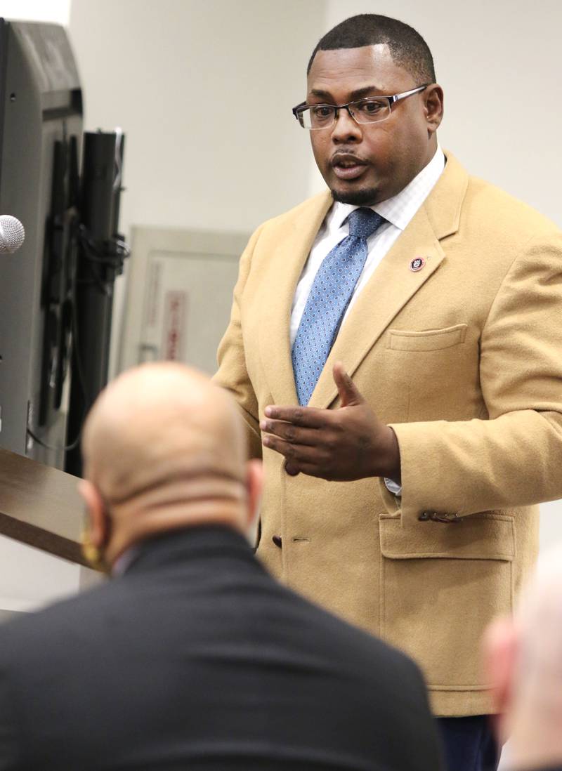 Earnell Brown, a member of the police chief search committee, talks to Illinois State Police Col. David Byrd Monday at the DeKalb City Council meeting about the qualities that made him the right selection to be the City of DeKalb's next police chief.