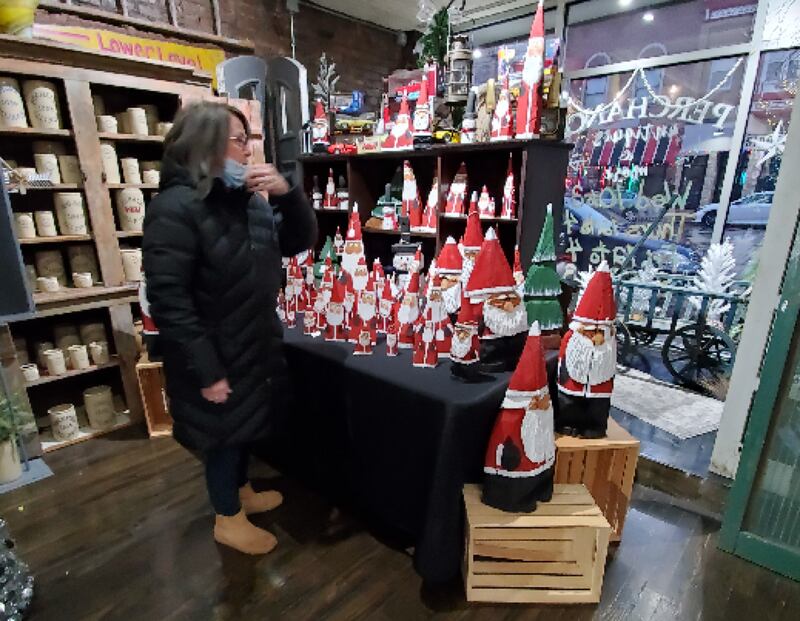 Shaw Local file photo – A shopper browses the holiday offerings at Perchance Antiques, 250 E. Lincoln Highway in downtown DeKalb in 2021 during the Merry Market, an annual vendor variety shopping weekend.