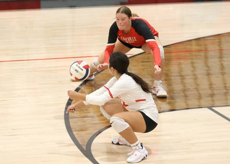 Earlville's Audrey Scherer and teammate Liz Vazquez misjudge a serve from Woodland on Wednesday, Sept. 25, 2024 at Woodland High School.