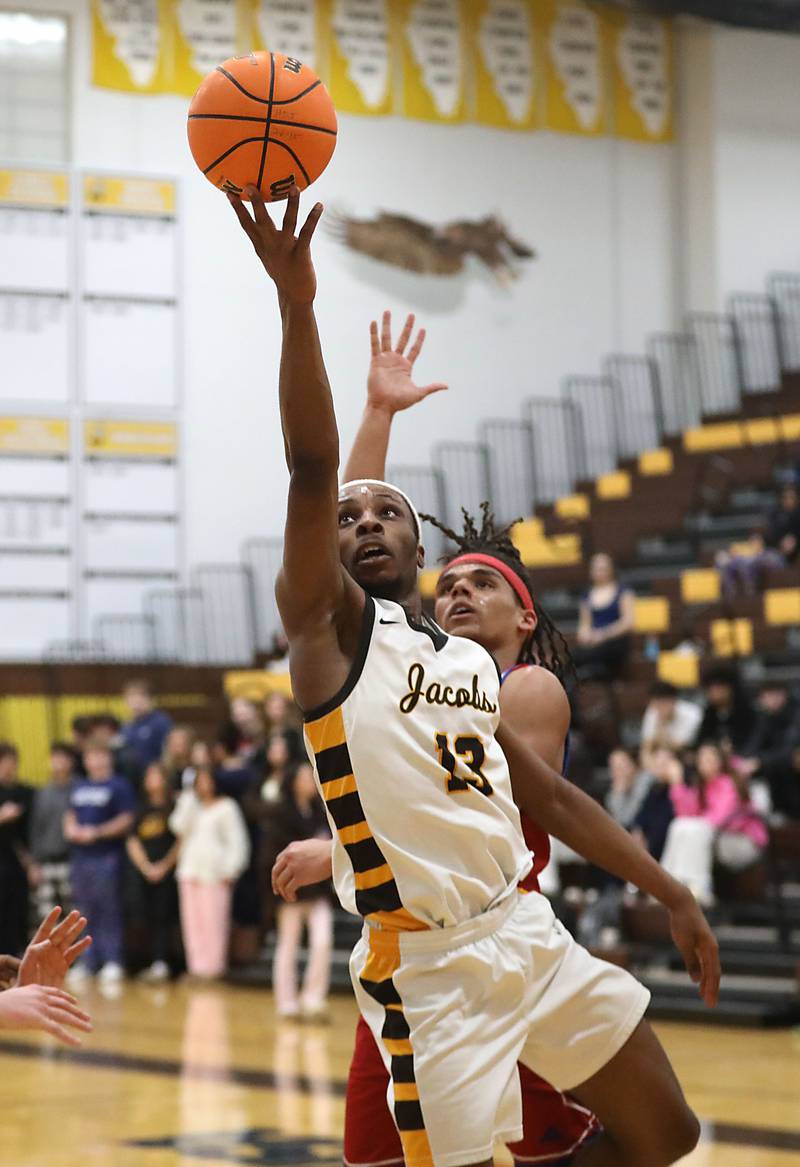Jacobs' Elijah Bell drives to the basket against Dundee-Crown's DeMario Rodriguez during a Fox Valley Conference boys basketball game on Tuesday, February. 3, 2026, at Jacobs High School in Algonquin.