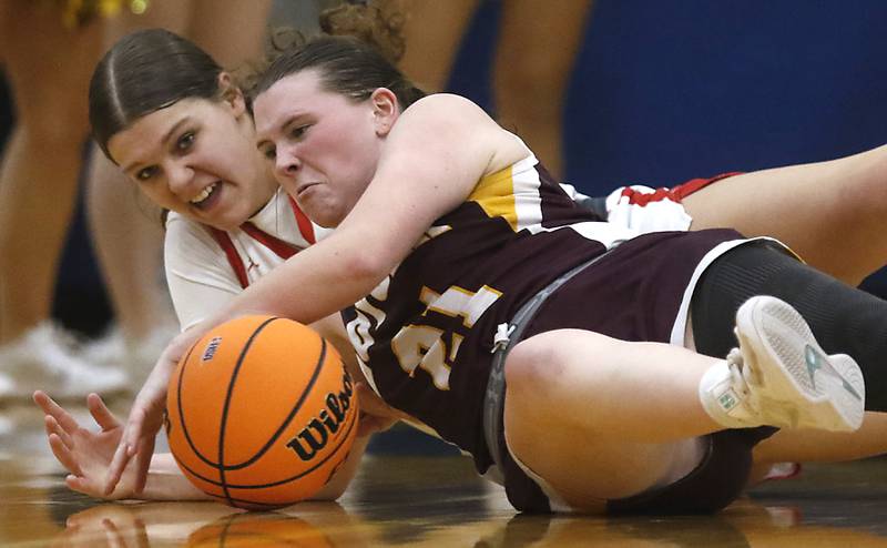 Huntley's Paula Strzelecki battles with Loyola Academy's Nora Emerson for a loose ball during the IHSA Class 4A Gurnee Warren Supersectional girls basketball game on Monday, March 3, 2025, at Warren Township High School in Gurnee.