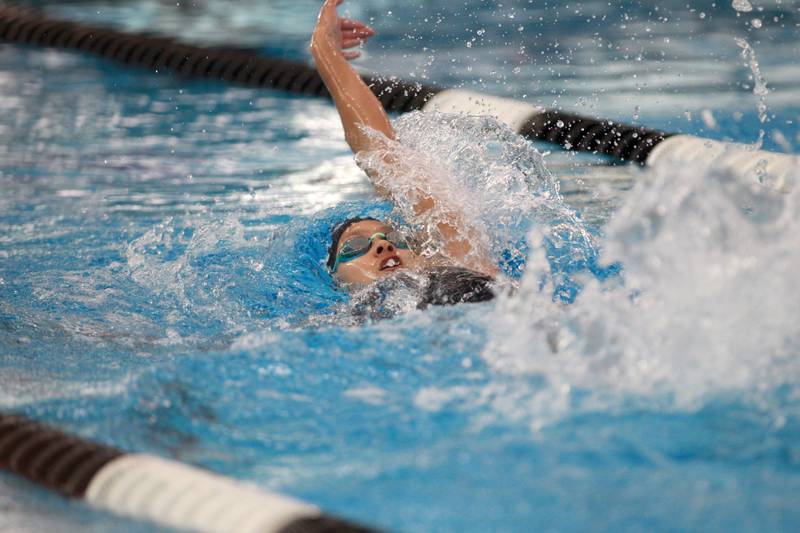 Lincoln-Way East’s Jaya Veerapaneni competes in the 100-yard backstroke championship heat during the IHSA Girls State Swimming and Diving Championships at the FMC Natatorium in Westmont on Saturday, Nov. 11, 2023.