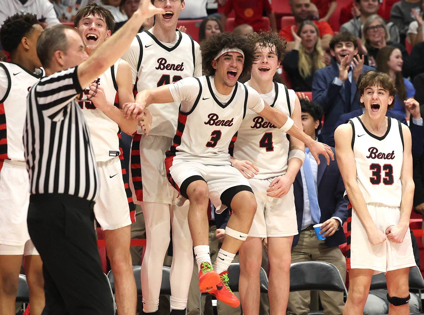 Benet players celebrate as time winds down Monday, March 9, 2026, in their IHSA Class 4A supersectional win over Auburn in the Convocation Center at Northern Illinois University in DeKalb.