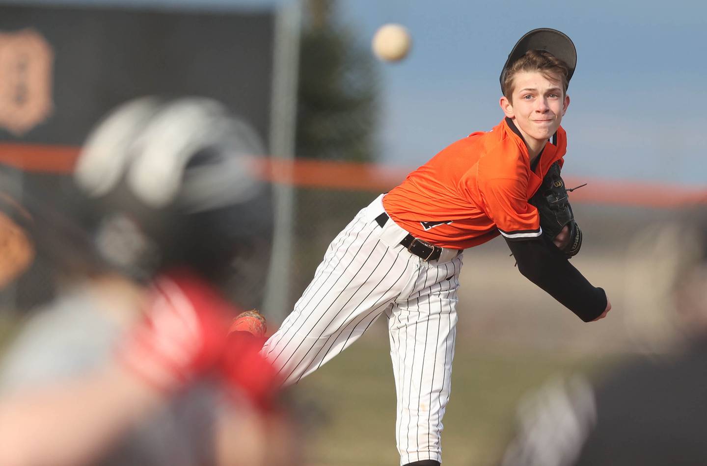 DeKalb's Jackson Kees loses his hat due to the wind as he delivers a pitch during their game against Jefferson Wednesday, April 6, 2022, at DeKalb High School.