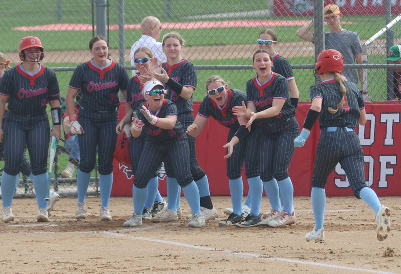 Ottawa's Teagan Darif is greeted by her teammates while running to home plate after smacking a home run against L-P on Tuesday, April 14, 2026 at Ottawa High School.