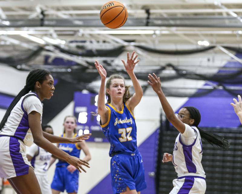 Johnsburg's Skye Toussaint (32) passes from the top of the key during their basketball game between Johnsburg at Plano, Monday Dec 16, 2024 in Plano.