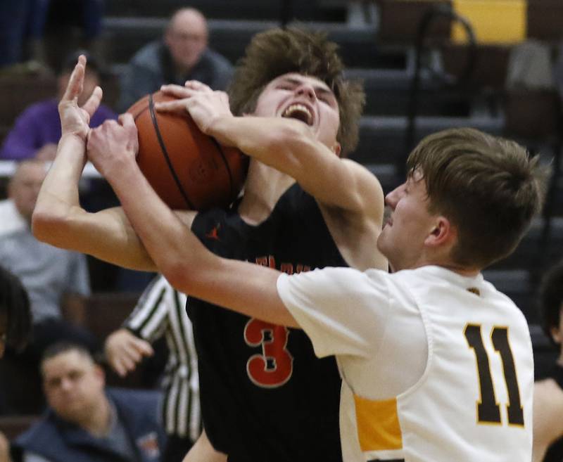 McHenry's Zachary Maness has the ball taken away by Jacobs' Carter Roper as he drive to the basket during a Fox Valley Conference basketball game Wednesday, Dec. 7, 2022, between Jacobs and McHenry at Jacobs High School in Algonquin.