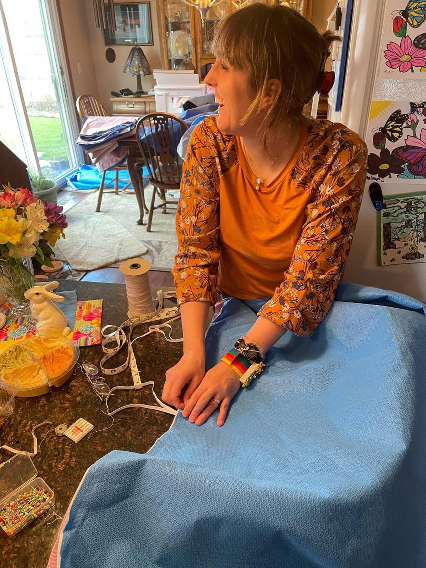 On Saturday, April 9, 2022, a small group of friends gathered at Kimberly Creasey's home in Joliet to create waterproof sleeping bags out of expired surgical drapes. The sleeping bags were sent to Poland, where they will be distributed to people from Ukraine in need. Pictured is Kayla Motto of New Lenox as she stiches the drapes together.