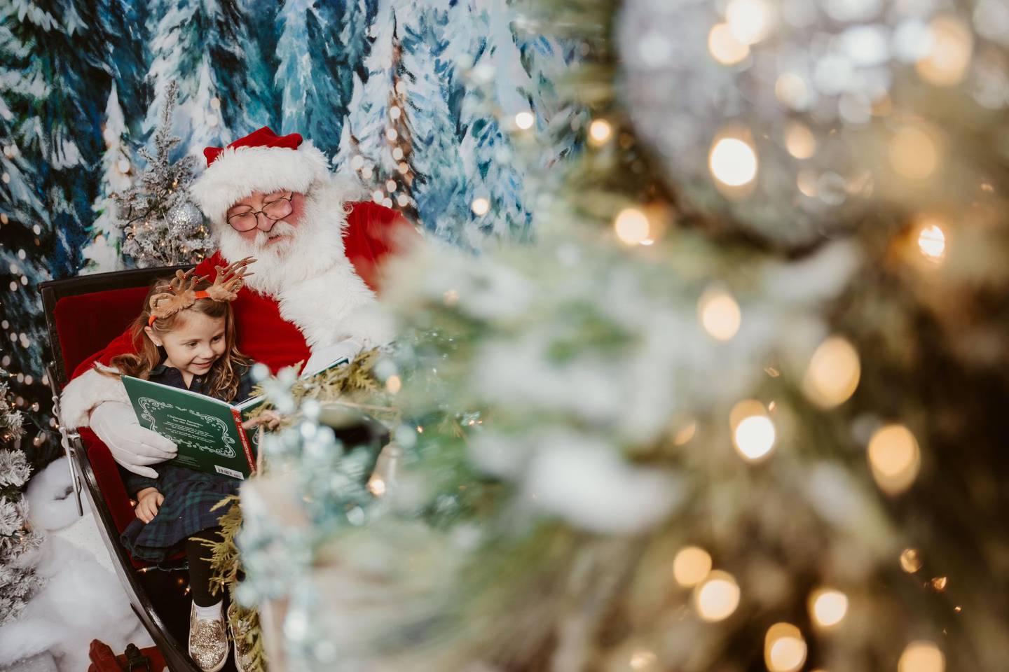 Eloise Lombardi (4) was first in line to tell Santa what she wants for Christmas at Locked In Photography during the annual Christmas walk in downtown Oswego on Friday, Dec. 2 2022.