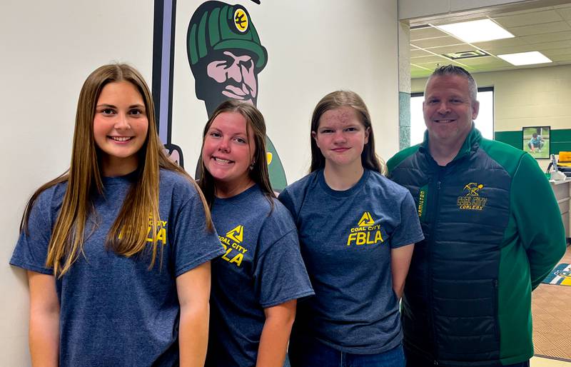 (From left) Kylee Kennell, Peyton Gibson, and Grace Sitar with Unit 1 Education Foundation President Shawn Hamilton, who presented them with a $750 check.