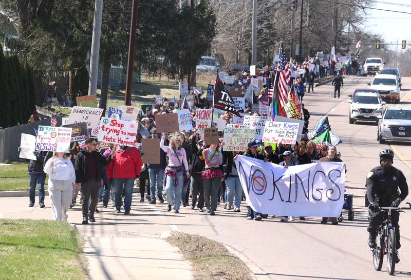 Protesters march north Saturday, March 28, 2026, on Sycamore Road in DeKalb during a No Kings march and rally against the federal actions of President Donald Trump and his administration.