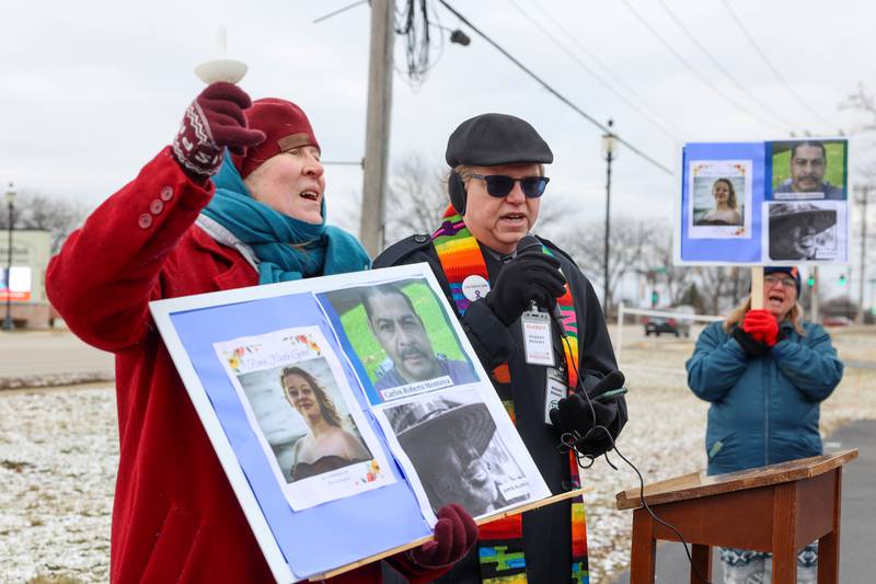 Pastors Robert Bushey, center, and Lana Robyne lead a crowd of about 100 in a song during an ICE Out for Good protest and vigil at The Grow Center in Bourbonnais on Sunday, Jan. 11, 2026. The event was planned in the wake of the shooting death of Renee Nicole Good by an ICE agent on Jan. 7 in Minneapolis, Minn.