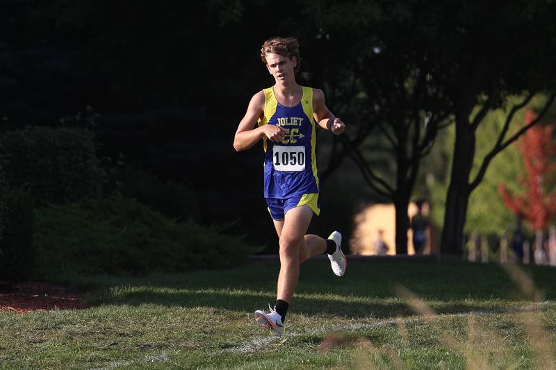 Joliet Central’s Myles Wedic holds his place at second midway in the Joliet West Cross Country Dual Meet on Monday, Aug. 28, 2023 in Joliet.