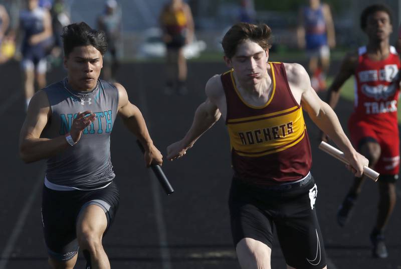 Woodstock North’s Mark Duenas, and Richmond-Burton’s Sean Rockwell race to the finish line in the 4 x 100 meter relay during the IHSA Class 2A Belvidere Boys Track and Field Sectional Thursday, May 19, 2022, at Belvidere High School.