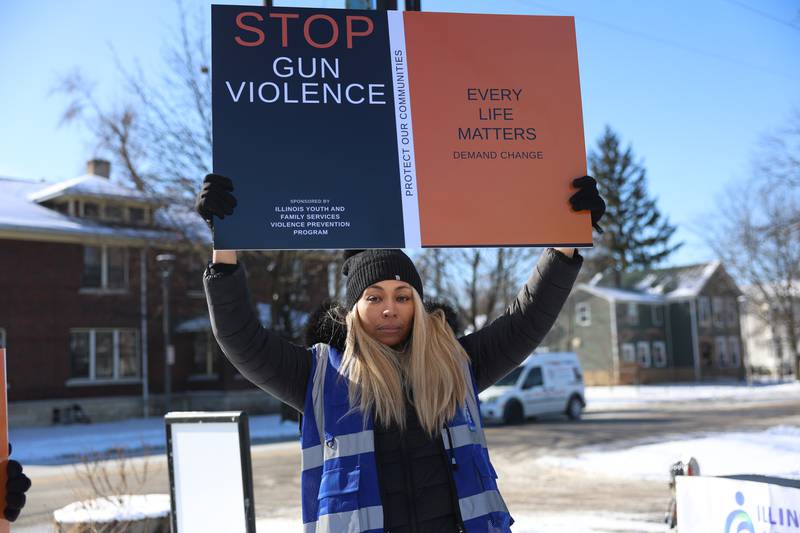 Illinois Youth & Family Services Executive Director Dr. Nauteia Brass holds signs along Richards Street for an Illinois Youth & Family Services anti violence rally on Monday, Jan. 26, 2026 in Joliet.