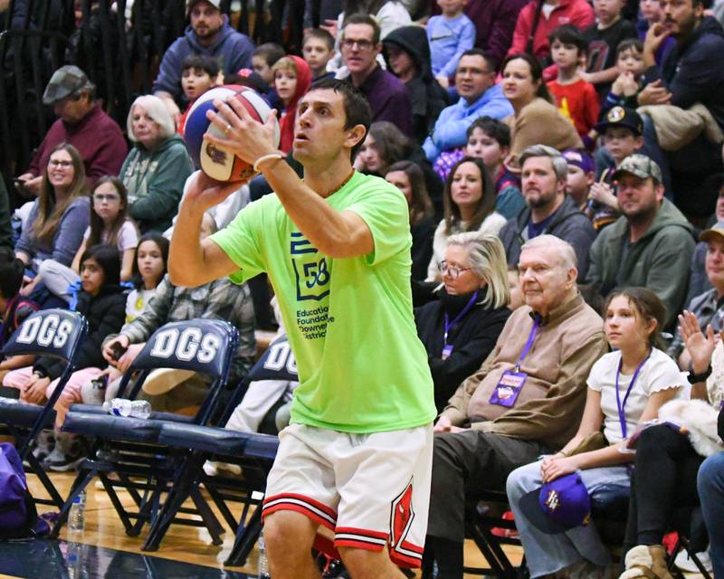 Matt Smigaj a Downers Grove staff member shoots the ball during the game on Sunday Jan. 19, 2025, while taking on the Harlem Wizard held at Downers Grove Souh High School.