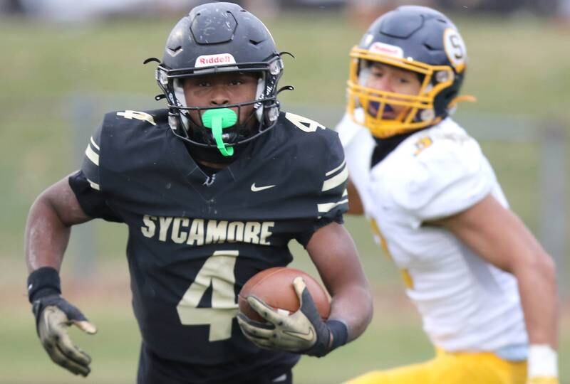 Sycamore's Tyler Curtis runs the ball after intercepting a Sterling pass late in the game sealing their win in their Class 5A state playoff game Saturday, Nov. 12, 2022, at Sycamore High School.