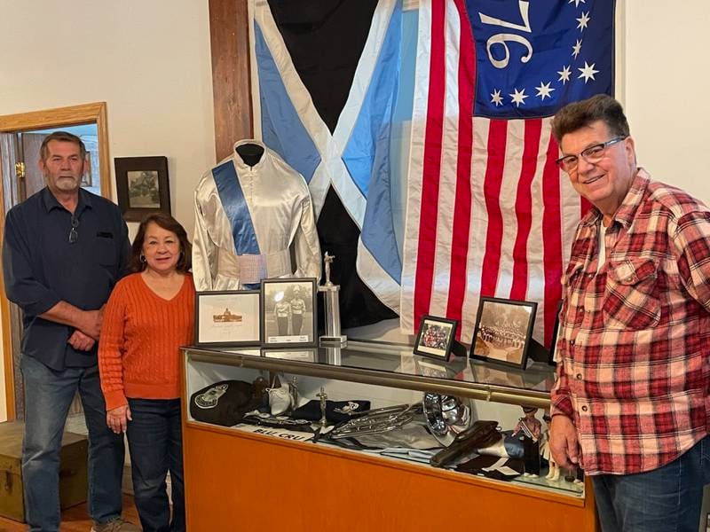 Steve Creed, Hope Kelly and Bob Anselme with the new display at the La Salle County Historical Museum. All three are former members of the Crusaders drum corps.