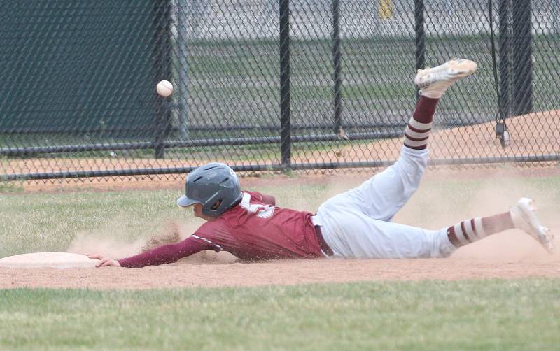 Morris's Lorenzo Zdanwic slides safely into third base as the ball sails over his head away from the play on Wednesday, April 17, 2024 at Huby Sarver Field inside the L-P Athletic Complex in La Salle.