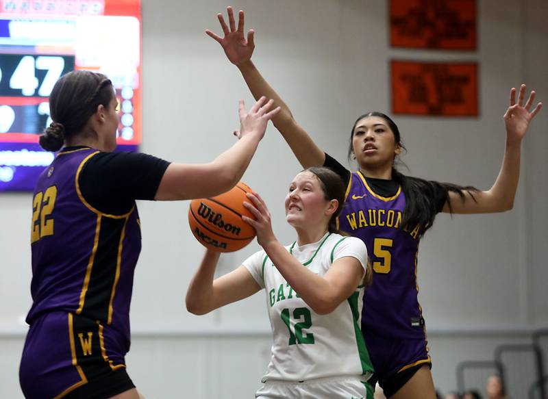 Crystal Lake South's Gaby Dzik shoots the ball between Wauconda's Kelsey Piehl (left) and Alessandra Rodriguez (right) during the Northern Illinois Holiday Classic Championship girl basketball game on Thursday, Dec. 18, 2025, at McHenry High School.