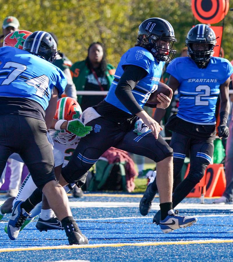 St. Francis' Alessio Milivojevic (11) scores a touchdown on a keeper against Morgan Park during a class 5A state quarterfinal football game at St. Francis High School in Wheaton on Saturday, Nov 11, 2023.