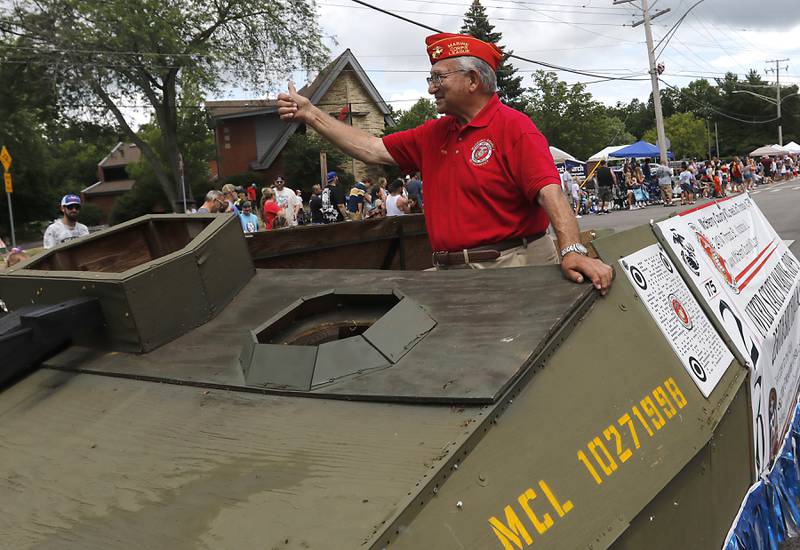 Tony Arnone of the McHenry County Marine Corps League waves to the crowd on Sunday, July 6, 2024, during Crystal Lake’s annual Independence Day Parade on Dole Avenue in Crystal Lake.