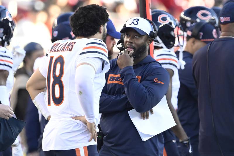 Chicago Bears quarterback Caleb Williams (18) talks with interim head coach Thomas Brown during the second half of an NFL football game against the San Francisco 49ers in Santa Clara, Calif., Sunday, Dec. 8, 2024. (AP Photo/Eakin Howard)