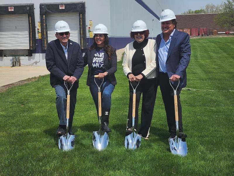 Family-owners of Compact Industries plant ceremonial shovels outside the distribution center at 420 37th Ave. in St. Charles, signifying the beginning of a $3.2 million, 33,000-square-foot expansion project.  (From left: Donald Brown, Tracey Brown-Miller, Dale Brown and Michael Brown)
