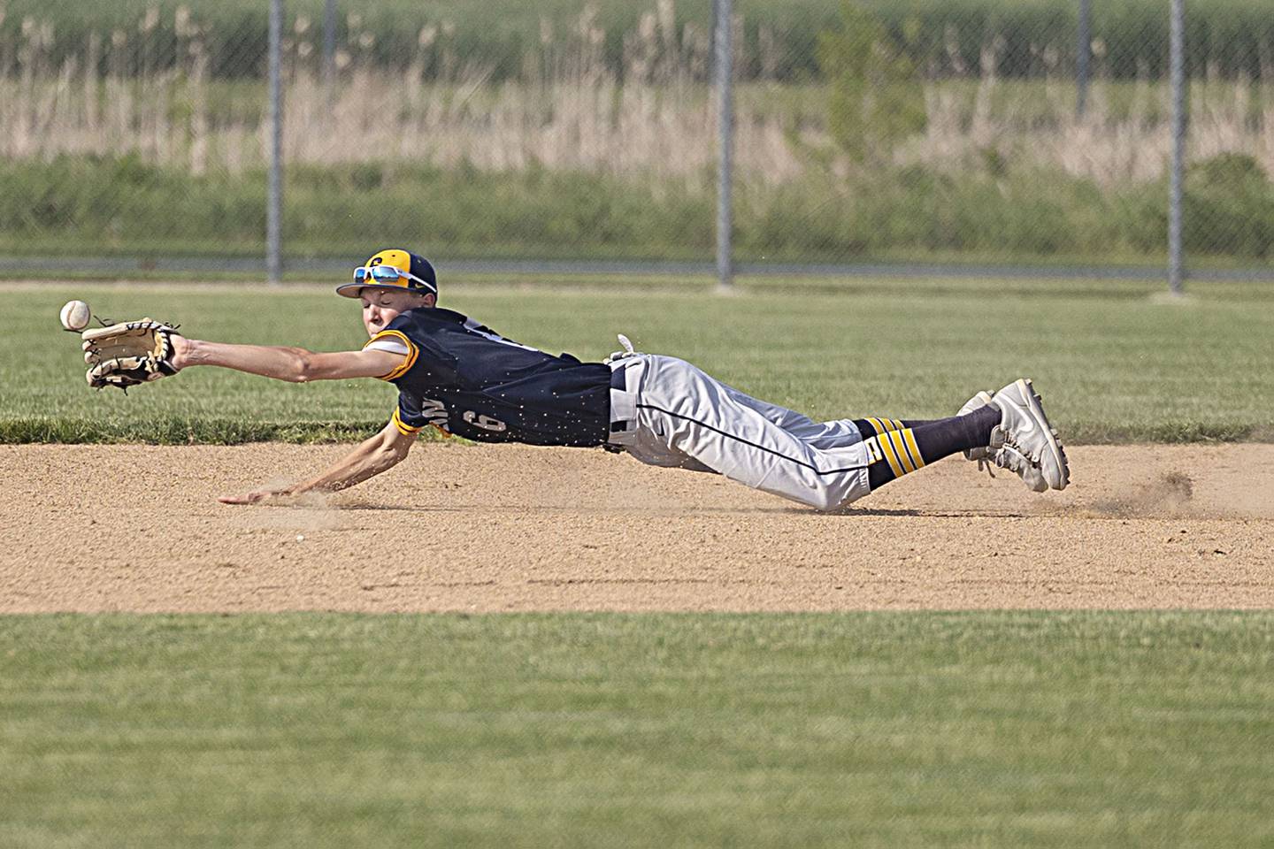Sterling’s Bryce Hartman dives but is unable to track down a grounder in the hole against Rochelle in class 3A regional action on Monday, May 22, 2023.