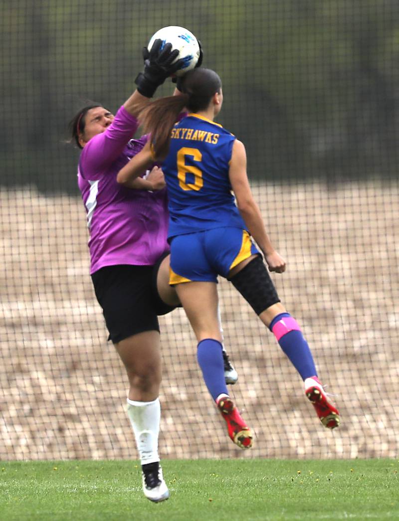 Harvard's Jarithsie Mercado Vergara grabs the ball as Johnsburg's Liz Smith tries to head the ball into the goal during a Kishwaukee River Conference soccer match on Wednesday, April 27, 2026, at Johnsburg High School.