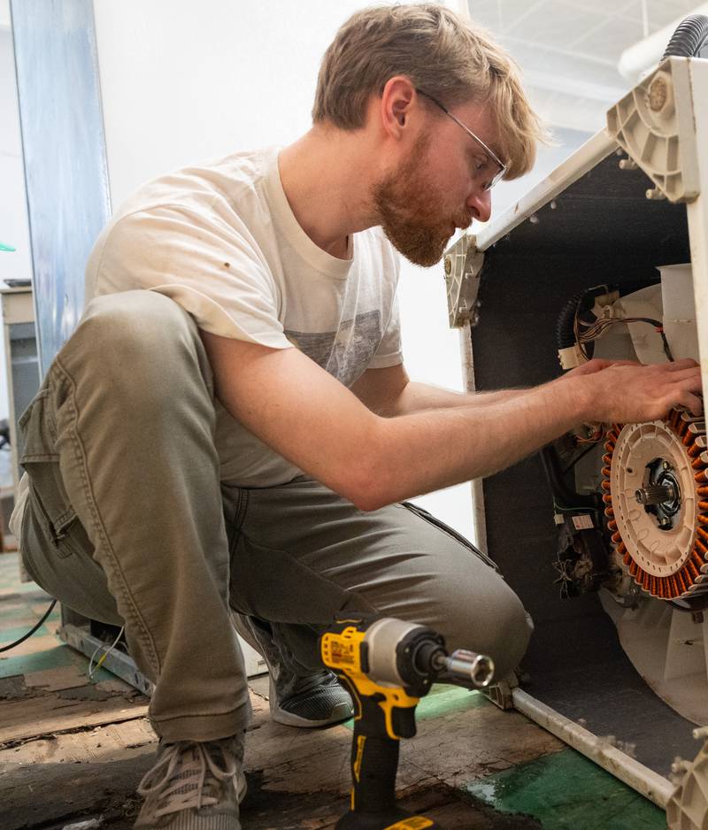 Kishwaukee College appliance repair technician student Jonathan Doty working on an appliance during class.