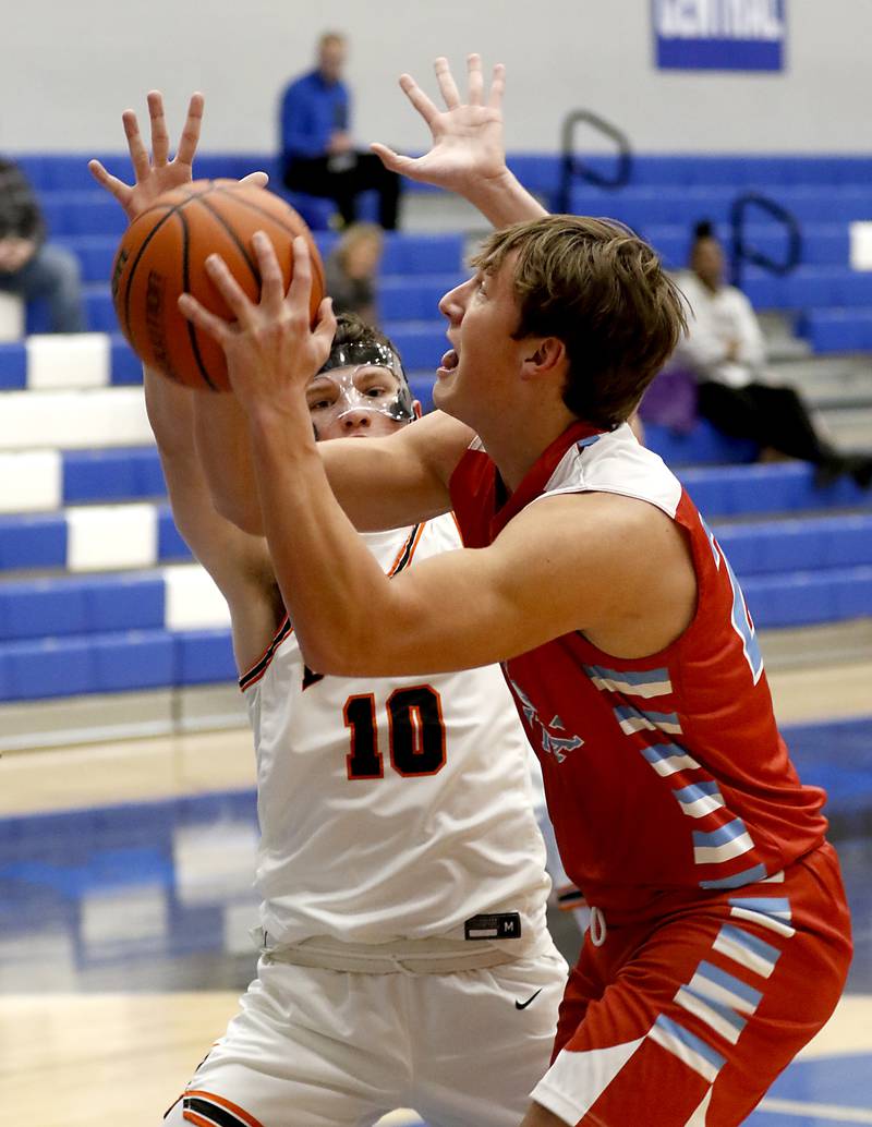 Marian Central's Christian Bentancur drives to the basket against DeKalb's Eric Rosenau during a Central High School’s Dr. Martin Luther King, Jr., Boys Basketball Tournament game Friday, Jan. 13, 2023, at Central High School in Burlington.