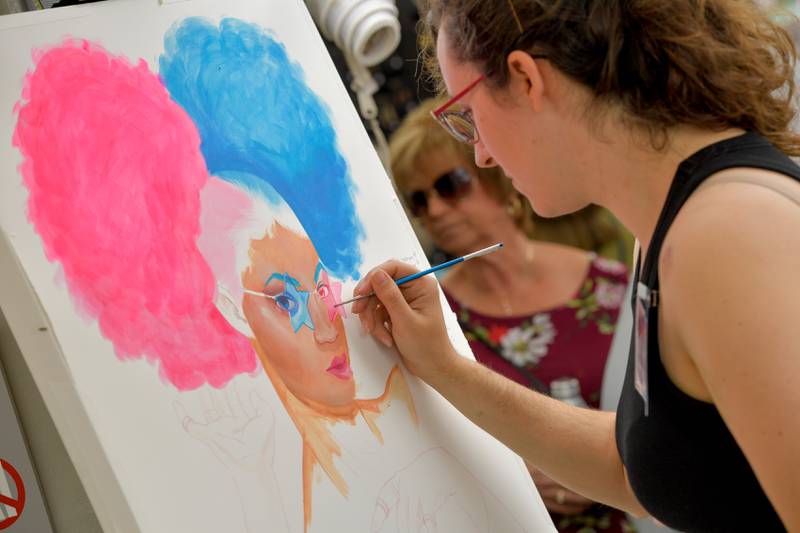 Kelsey Merkle of Buffalo New York works on a a piece while  showing her work at the St. Charles Fine Art Show on Saturday, May 27, 2023.