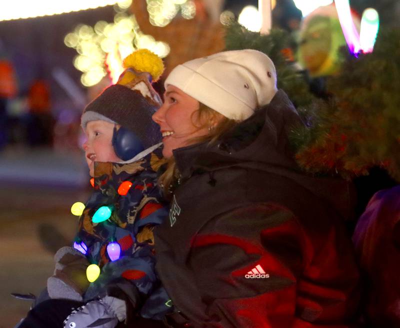 Maggie Mueller of Crystal Lake watches with her nephew Zach Kratenstein, 5, during the Festival of Lights Holiday Parade in downtown Crystal Lake on Fariday, Nov. 29, 2024.