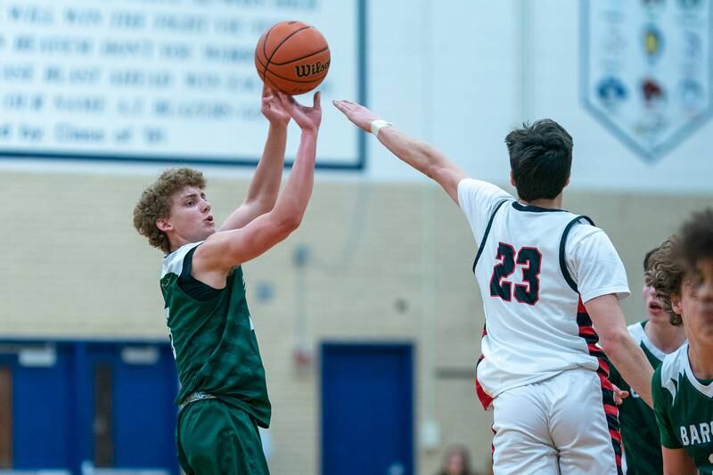 Bartlett's Nathan Scearce (5) shoots a three-pointer against Benet’s Nikola Abusara (23) during the 4A Addison Trail Regional final at Addison Trail High School in Addison on Friday, Feb 24, 2023.