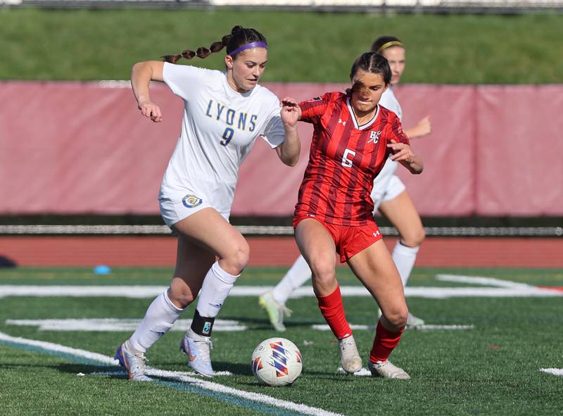 Lyons Township's Katie O'Malley (9) goes up against Hinsdale Central's Julia Marinaccio (6) during the girls varsity soccer match between Lyons Township and Hinsdale Central high schools in Hinsdale on Tuesday, April 18, 2023.