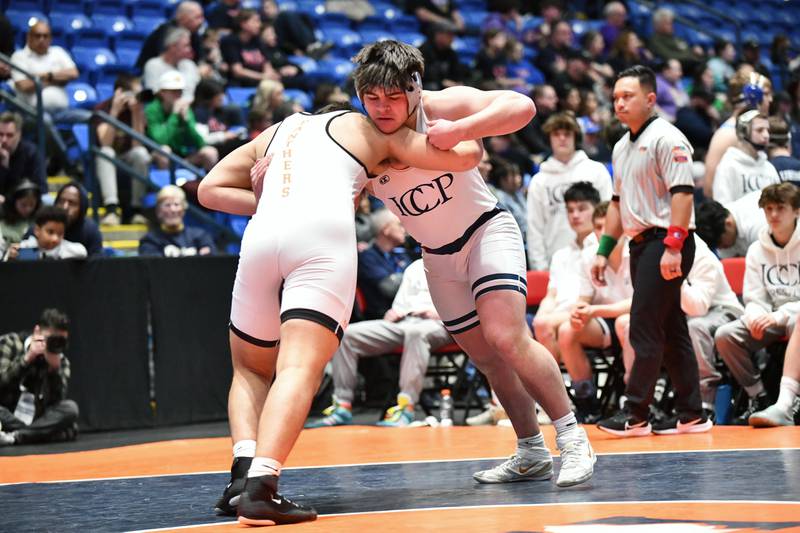 Foley Calcagno of IC Catholic wrestles Josh Hoffer of Washington in the 215-pound match during the IHSA Dual Team State Finals in Bloomington on Saturday, March 1.